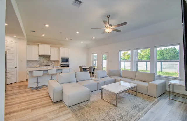a living room with furniture and a large window