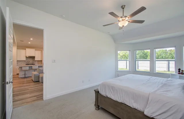 a bedroom with a large bed and a chandelier