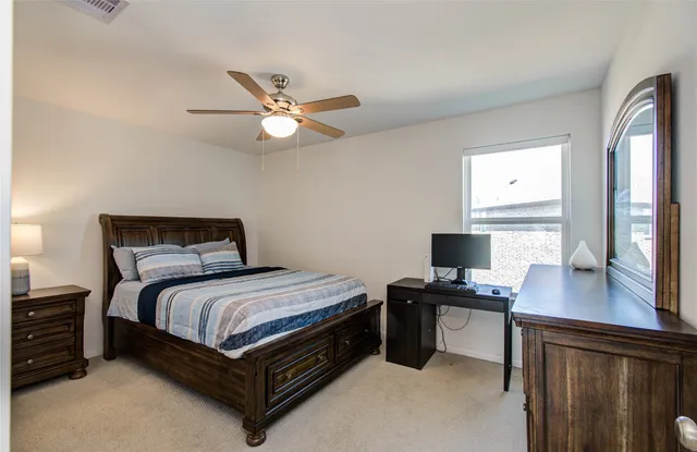 a bedroom with a bed and a desk