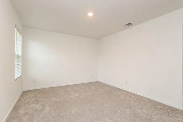 an empty room with a empty space and windows