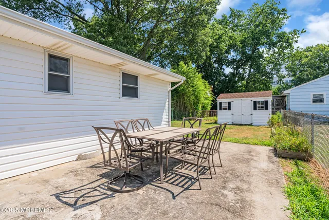 a view of backyard with seating space and trees