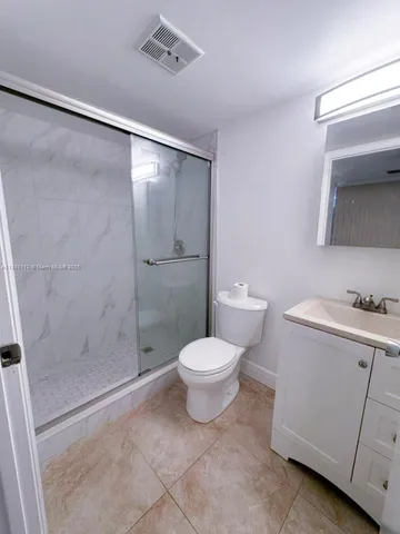 a bathroom with a toilet sink and shower