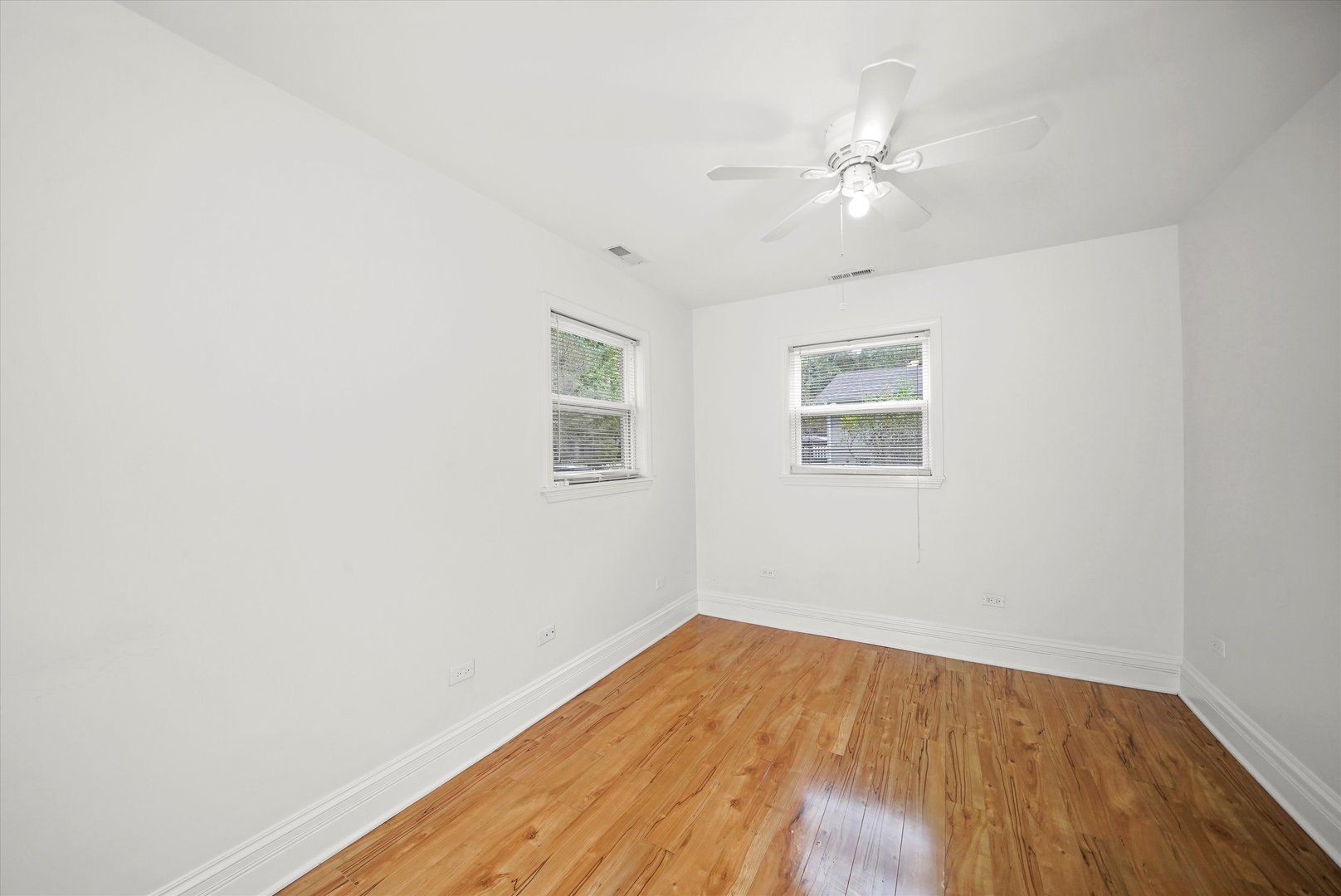 37936 North Wilson Avenue Beach Park, IL 60087 - Photo 9 of 16 a view of a room with wooden floor and a ceiling fan