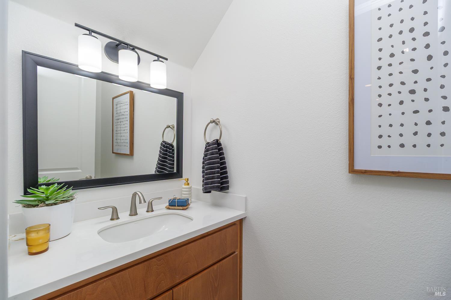 1201 Del Rancho Way Petaluma, CA 94954 - Photo 13 of 56 a bathroom with a granite countertop sink and a mirror