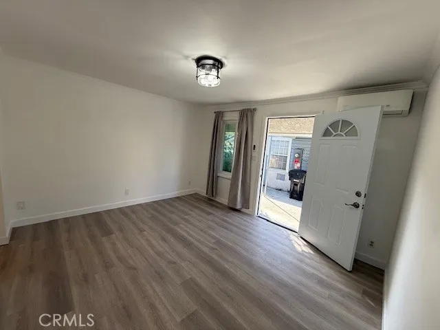 an empty room with wooden floor and closet