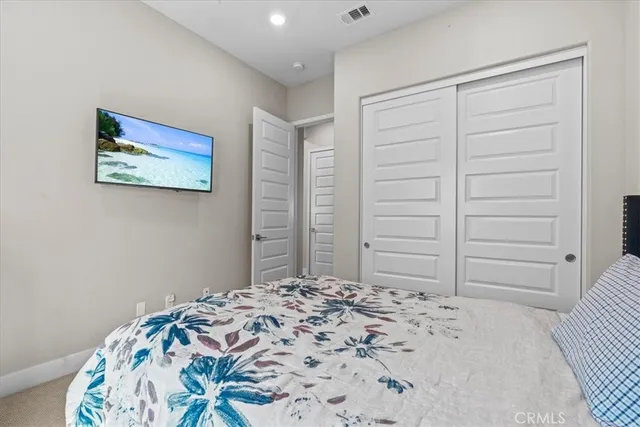 a bedroom with a bed and a closet