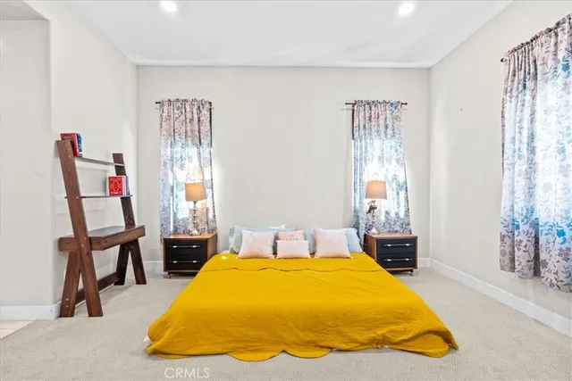 a bed sitting in a bedroom next to a window