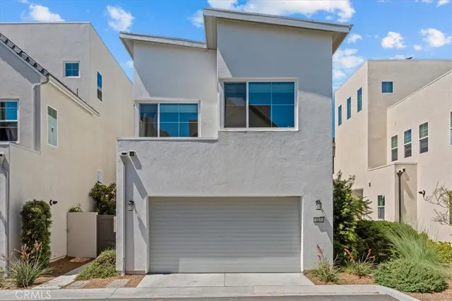 a front view of a house with plants