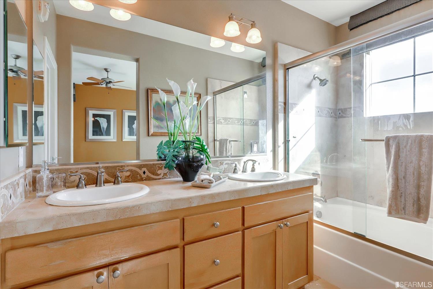 6010 Old Quarry Loop Oakland, CA 94605 - Photo 26 of 32 a bathroom with a granite countertop sink mirror and a bathtub