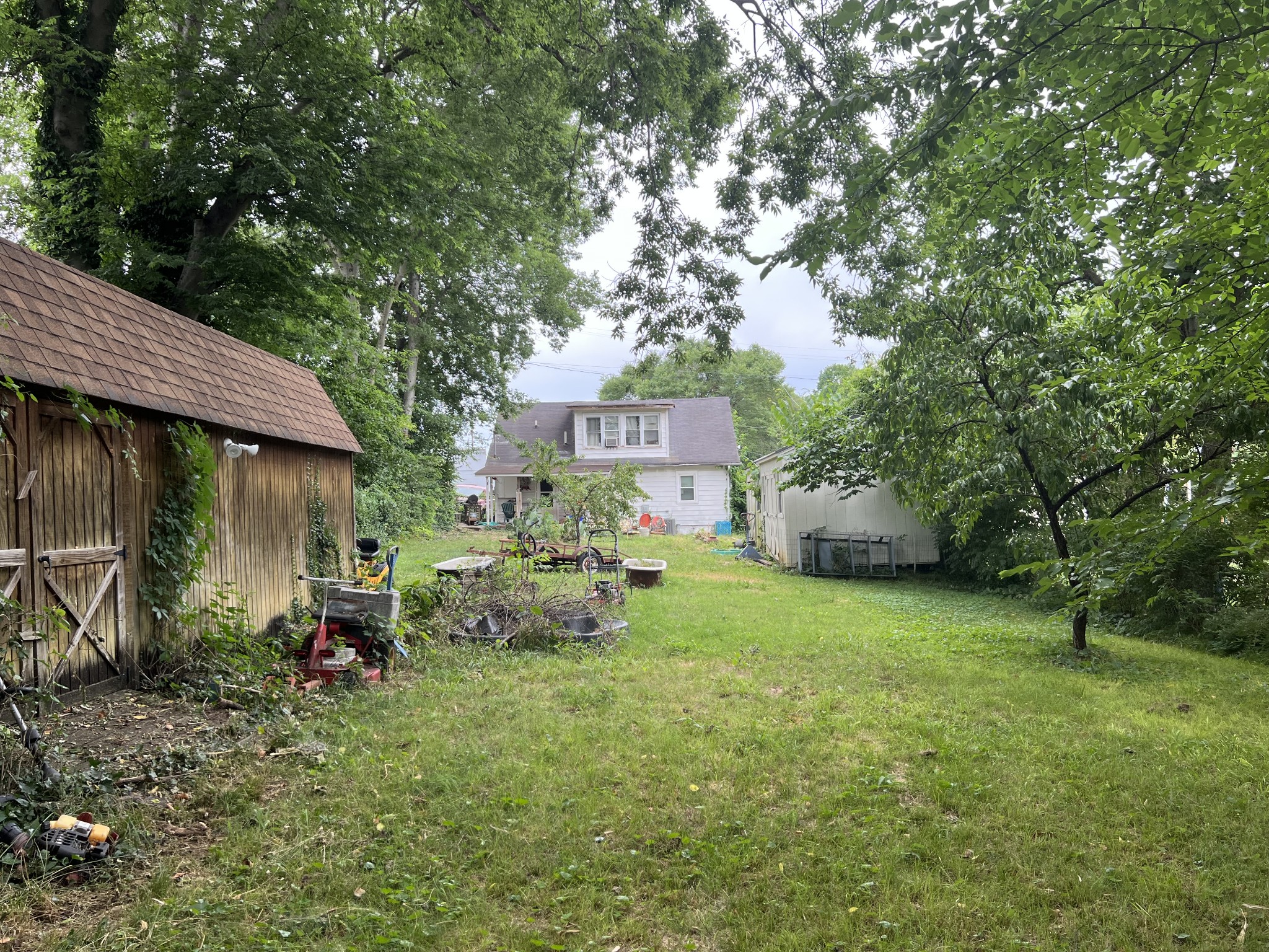 104 Lanier Drive Madison, TN 37115 - Photo 3 of 20 a view of a chair and tables in the yard and large trees