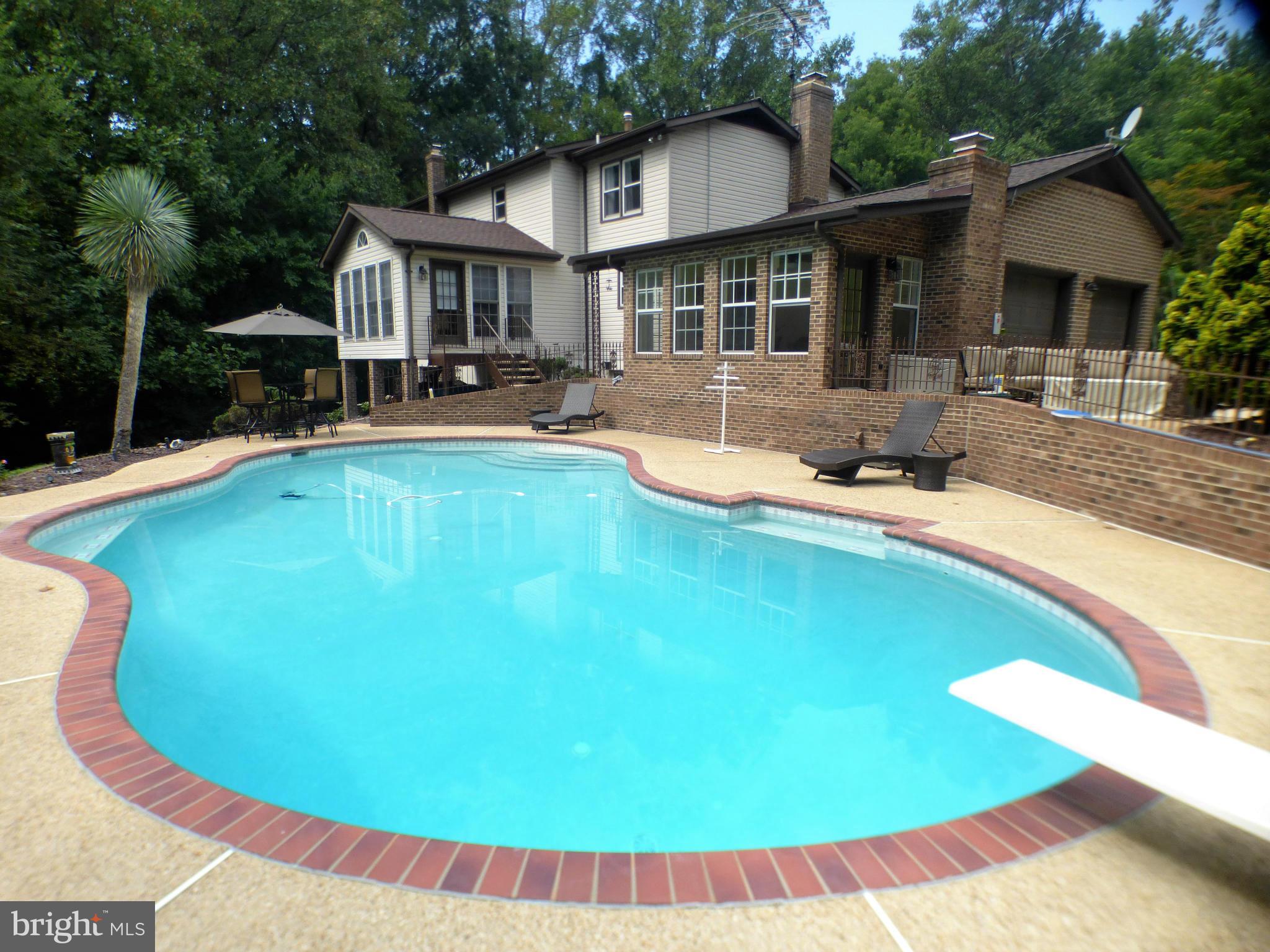 1521 Stinnett Road Huntingtown, MD 20639 - Photo 2 of 30 a view of a house with swimming pool and porch