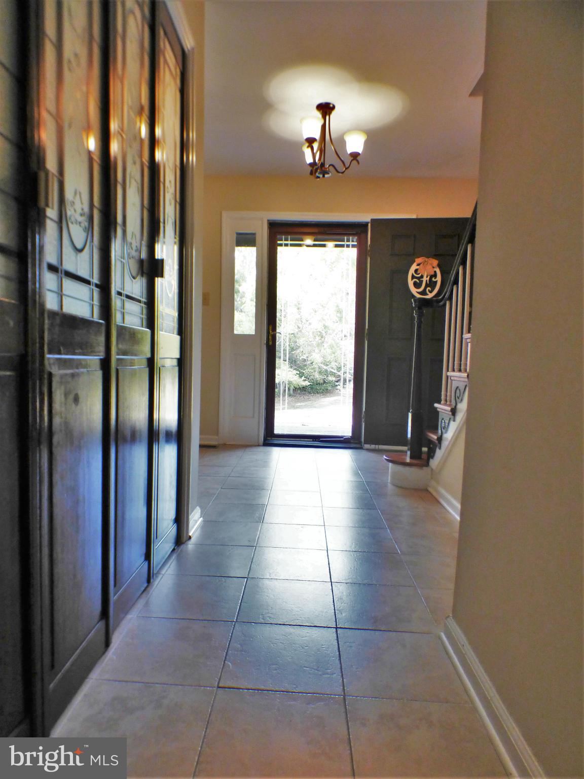 1521 Stinnett Road Huntingtown, MD 20639 - Photo 15 of 30 a view of a hallway with windows and chandelier