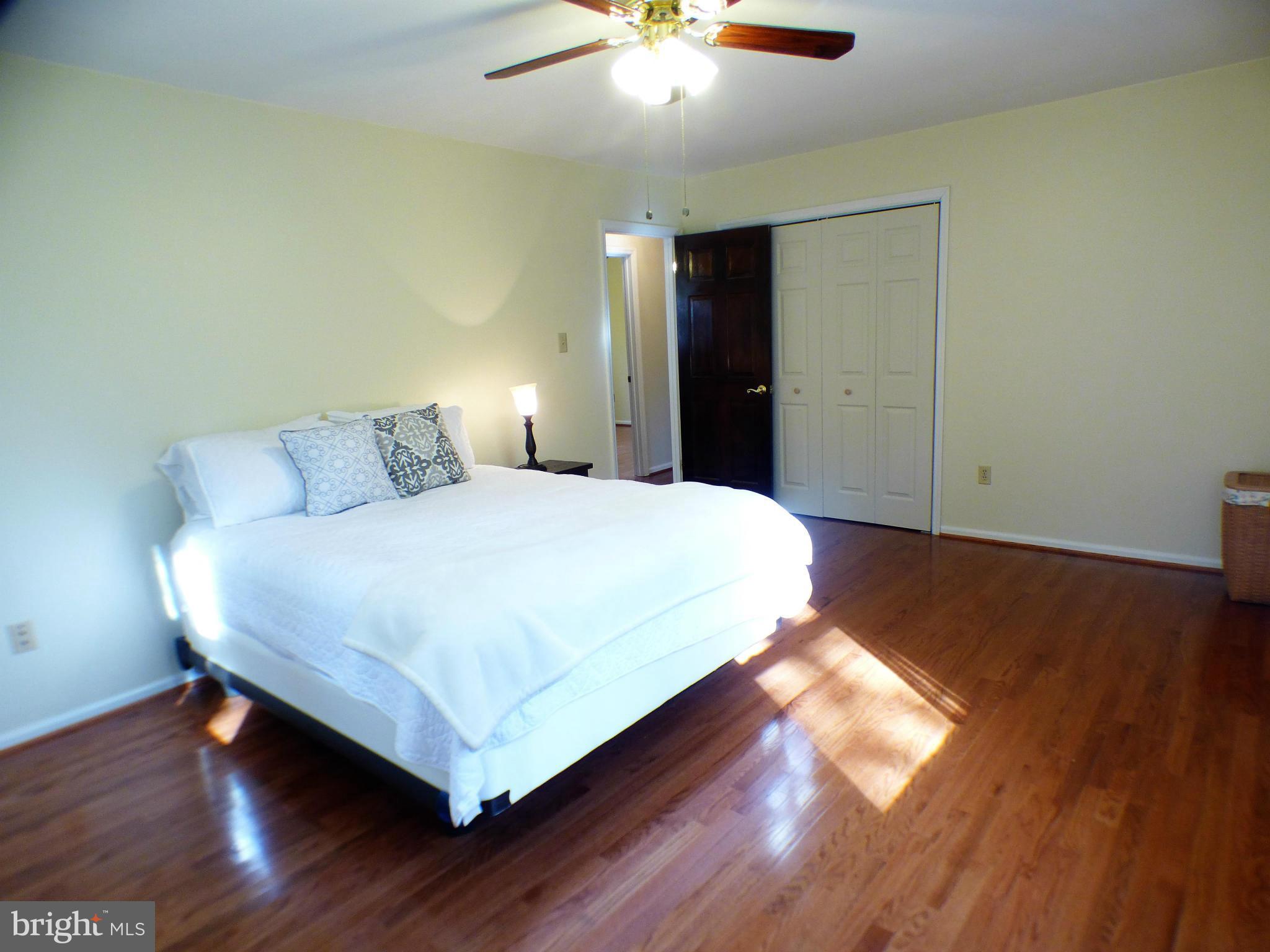 1521 Stinnett Road Huntingtown, MD 20639 - Photo 20 of 30 a bedroom with a bed and a potted plant on the table
