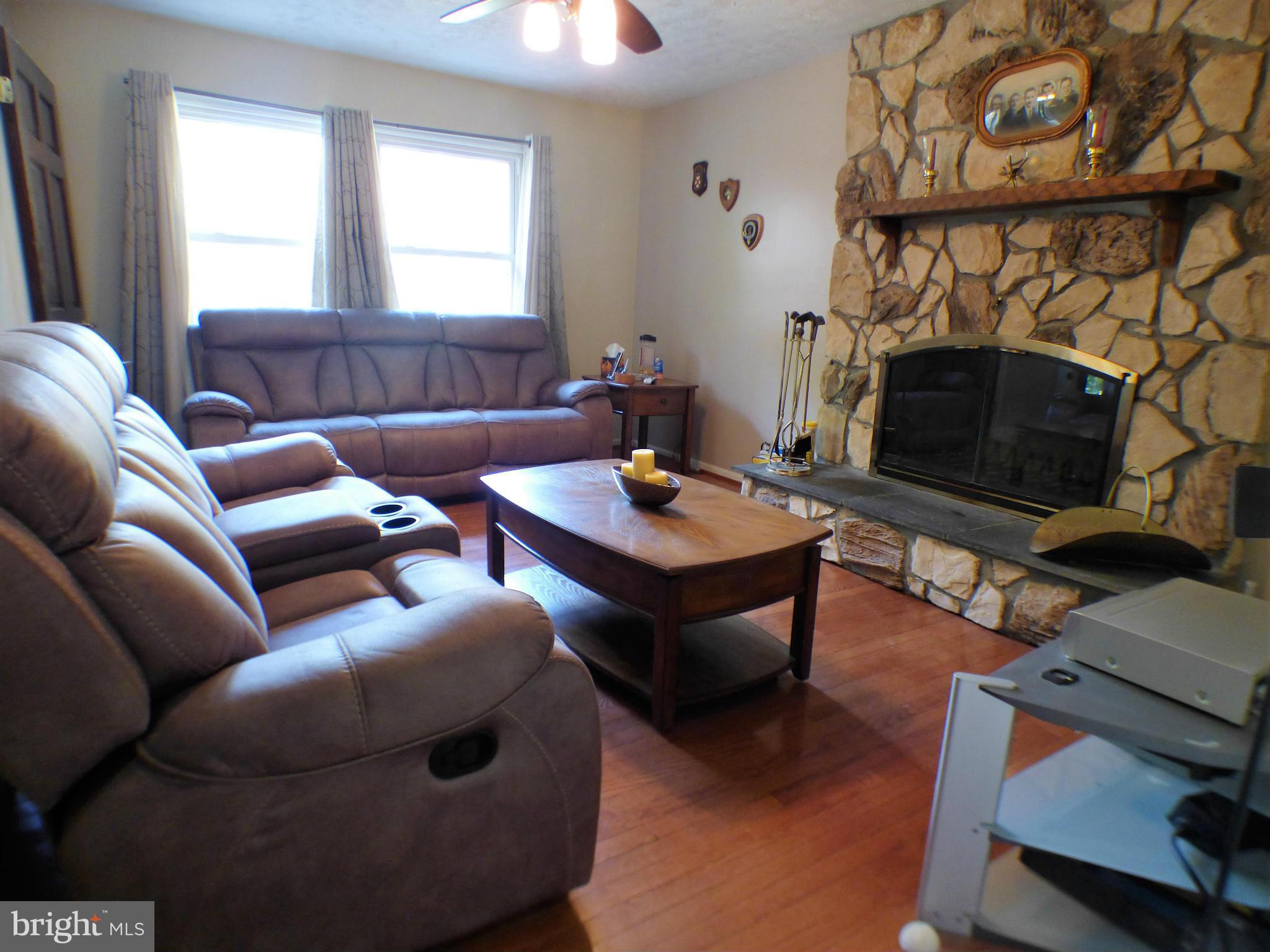 1521 Stinnett Road Huntingtown, MD 20639 - Photo 3 of 30 a living room with furniture a fireplace and a window