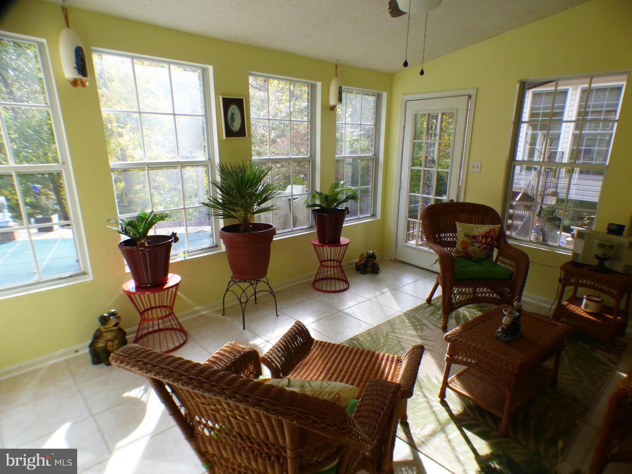 1521 Stinnett Road Huntingtown, MD 20639 - Photo 24 of 30 a living room with furniture and floor to ceiling windows