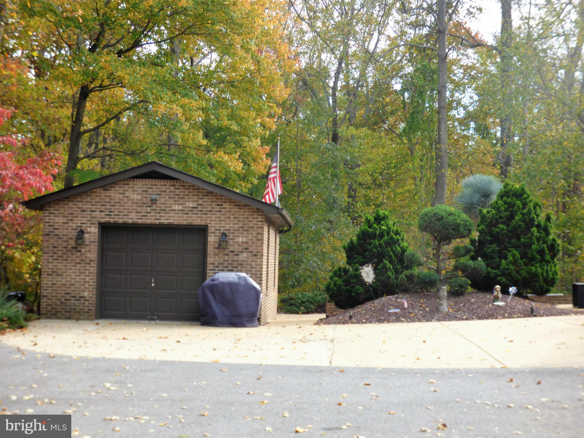1521 Stinnett Road Huntingtown, MD 20639 - Photo 26 of 30 a front view of a house with a yard and garage