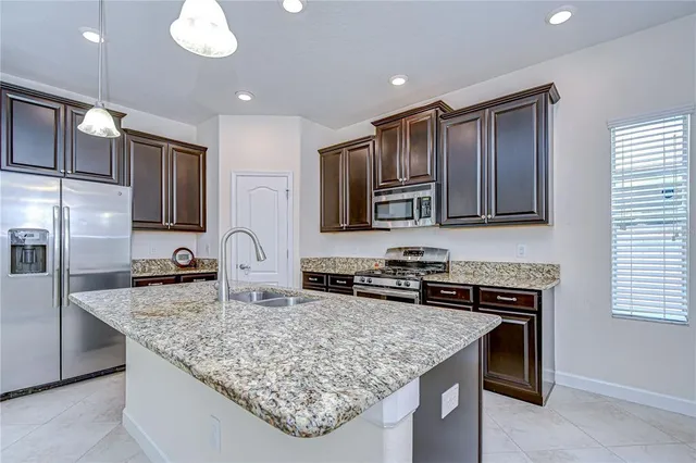 a view of kitchen with refrigerator stove and oven