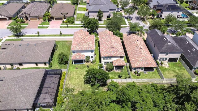 an aerial view of multiple houses with yard