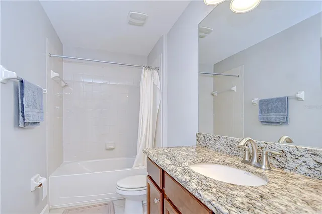 a view of a building with a yard and potted plants