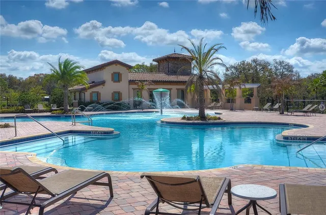 a swimming pool with outdoor seating and yard