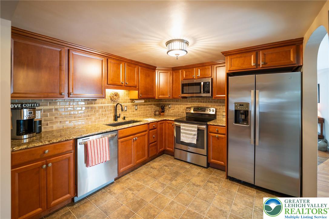 100 Ridge Road Phillipsburg, NJ 08865 - Photo 19 of 40 a kitchen with stainless steel appliances granite countertop a refrigerator a stove a sink and dishwasher