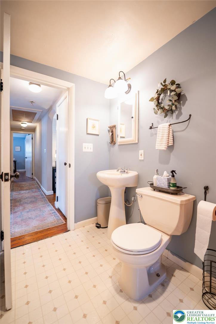 100 Ridge Road Phillipsburg, NJ 08865 - Photo 25 of 40 a white toilet sitting next to a bathroom sink and a mirror