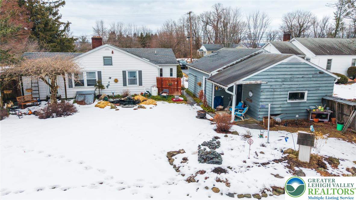 100 Ridge Road Phillipsburg, NJ 08865 - Photo 4 of 40 a view of a white house with a yard covered in snow