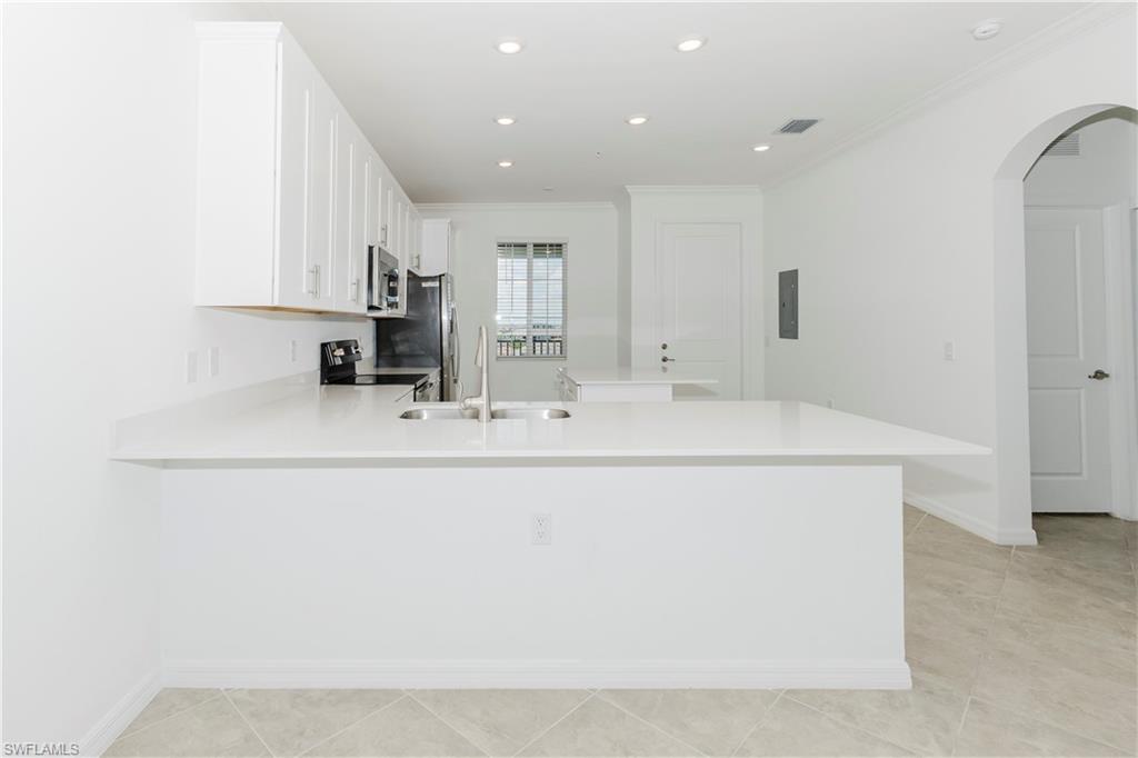 6034 National Boulevard, Unit 544 Ave Maria, FL 34142 - Photo 2 of 48 a bathroom with a sink and a mirror