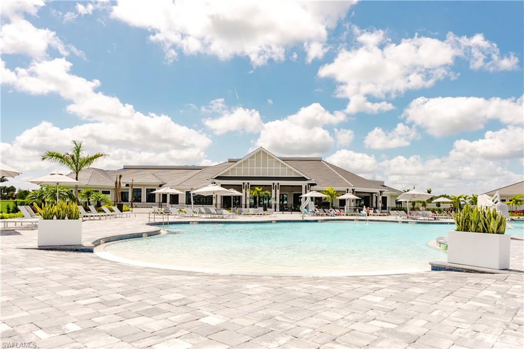 6034 National Boulevard, Unit 544 Ave Maria, FL 34142 - Photo 40 of 48 a view of a lake with a house in the background
