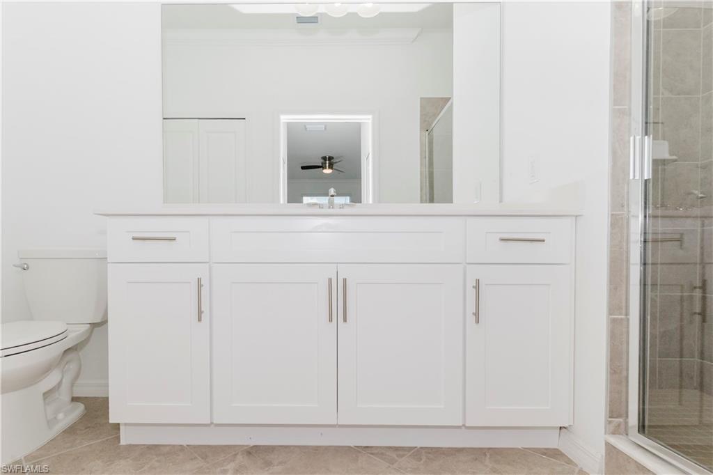 6034 National Boulevard, Unit 544 Ave Maria, FL 34142 - Photo 7 of 48 a bathroom with a sink and a mirror