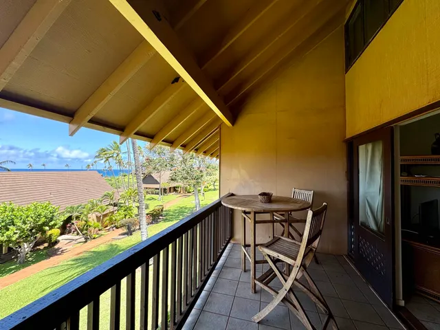 a view of a balcony with chairs and a table