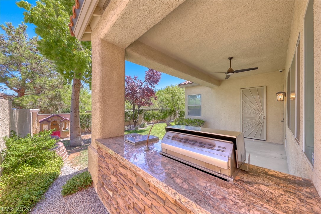 2122 Mooreview Street Henderson, NV 89012 - Photo 37 of 44 An inviting outdoor kitchen area with a built-in grill offers an ideal space for al fresco dining.
