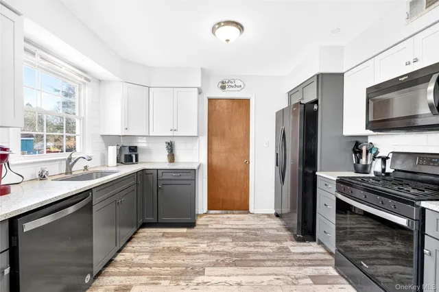 a kitchen with a sink stove and refrigerator