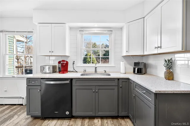 a kitchen with a sink window and cabinets