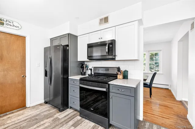 a kitchen with stainless steel appliances a stove microwave and a refrigerator