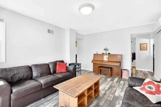 a living room with a couch and a dresser