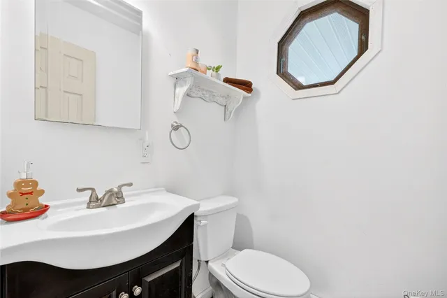 a bathroom with a sink toilet and a mirror