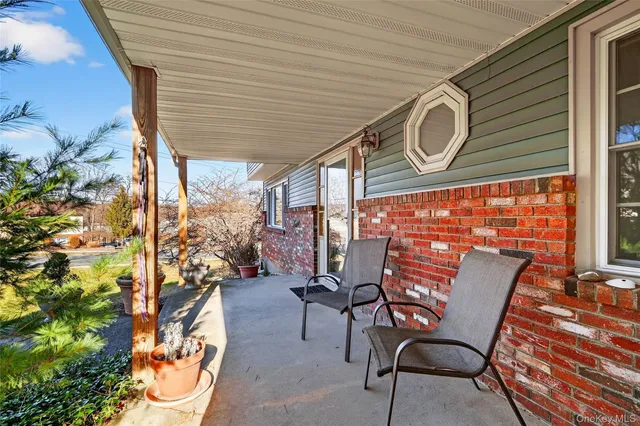 a view of a chairs and table in the balcony