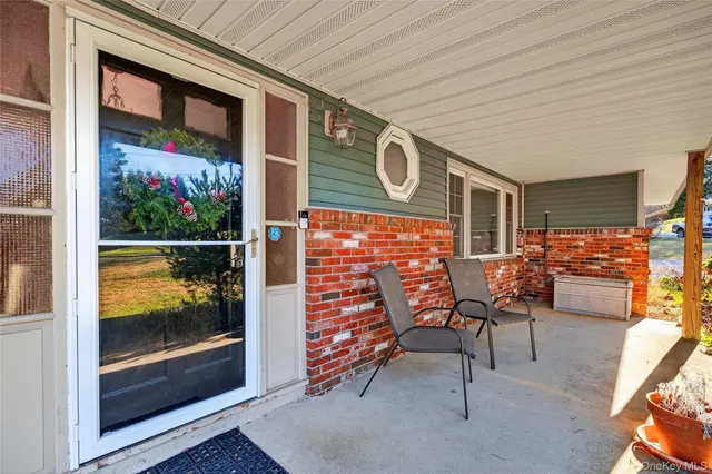 a view of a chairs and table in the balcony