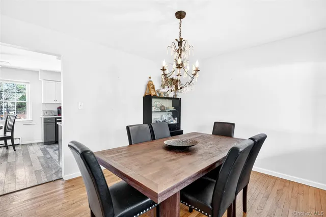 a view of a dining room with furniture wooden floor and chandelier