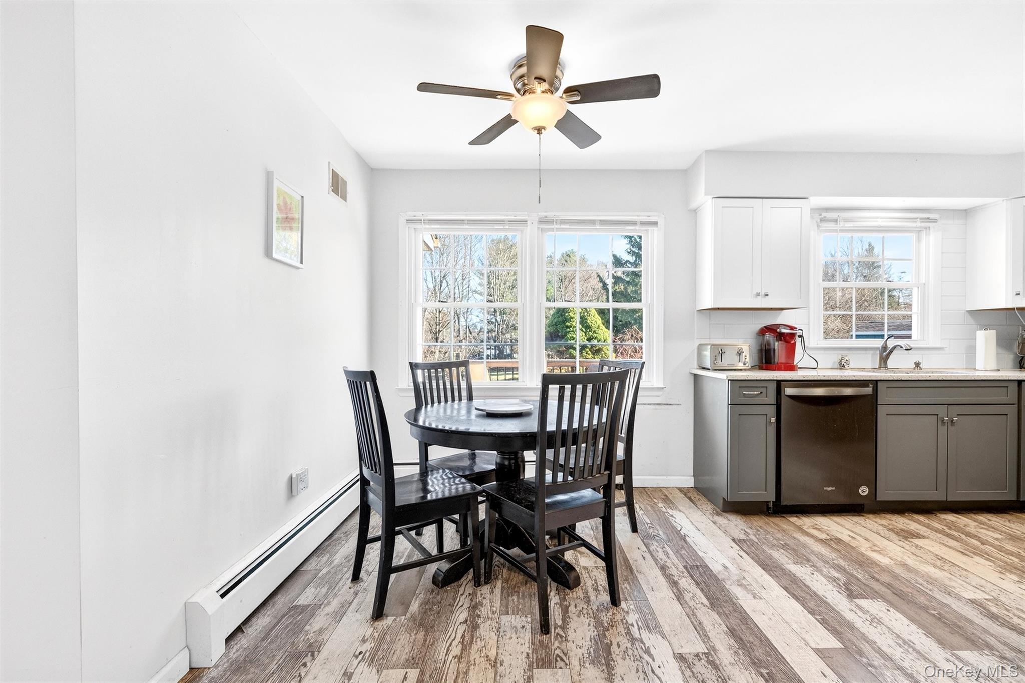 7 O Sullivan Lane Monroe, NY 10950 - Photo 9 of 43 a kitchen with a table chairs a sink dishwasher window and cabinets