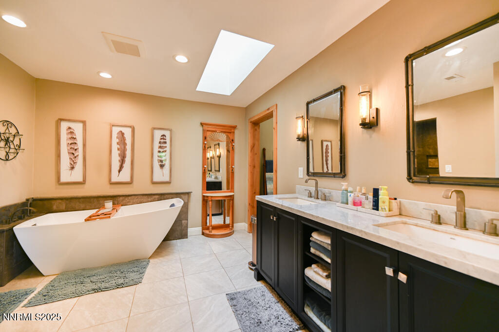 1147 Autumn Hills Road Gardnerville, NV 89460 - Photo 33 of 53 a spacious bathroom with a tub sink and mirror