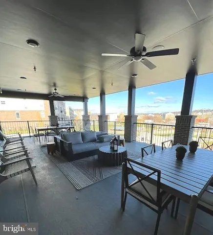 a living room with furniture and a floor to ceiling window