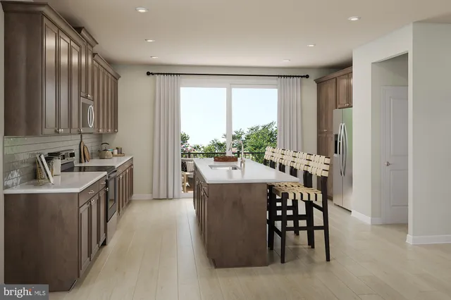 a kitchen with kitchen island a sink table and chairs