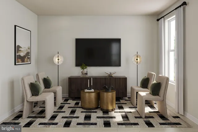 a living room with furniture a flat screen tv and kitchen view