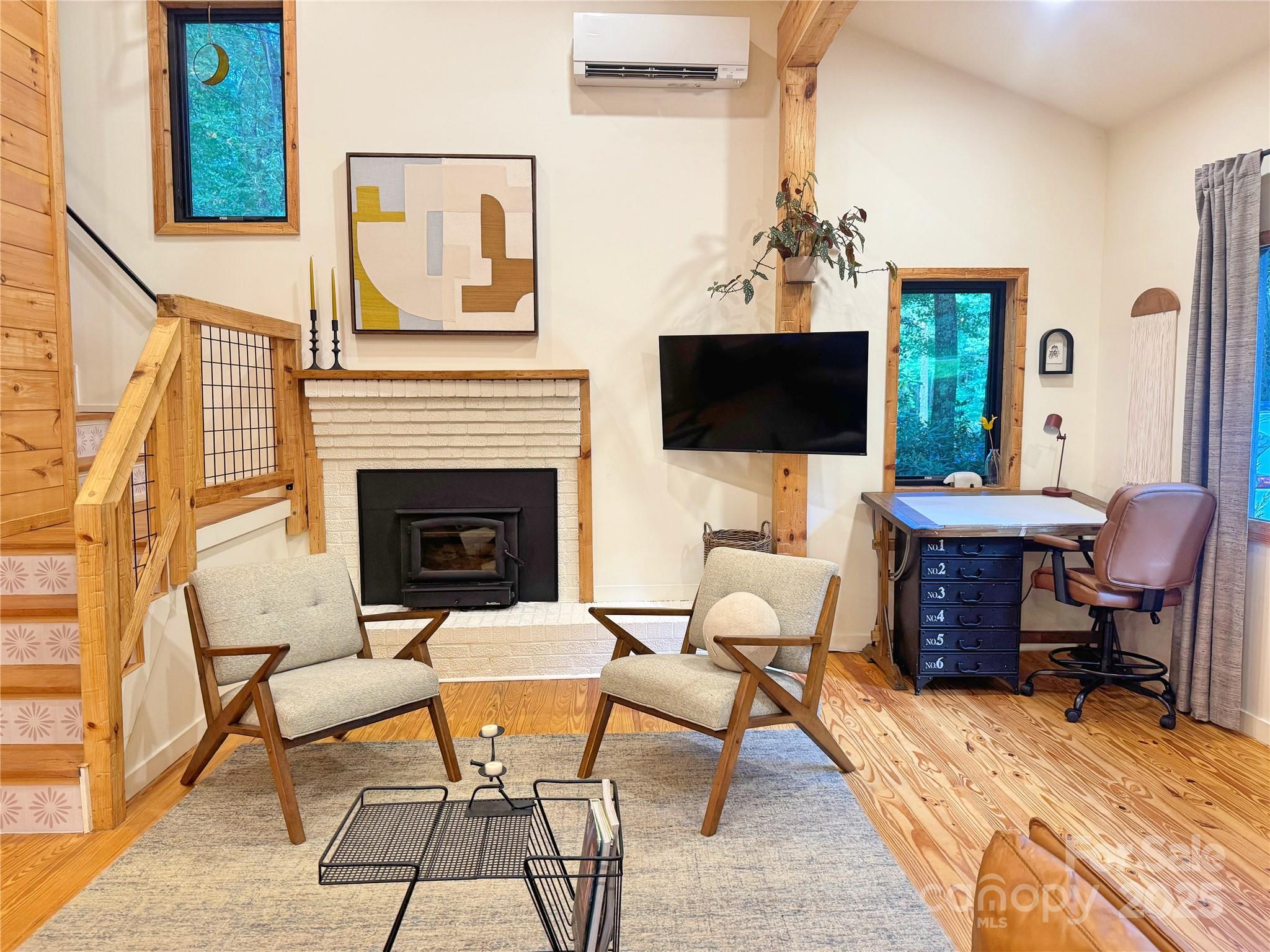 6622 Gingercake Road Newland, NC 28657 - Photo 18 of 48 a living room with furniture a fireplace and a flat screen tv