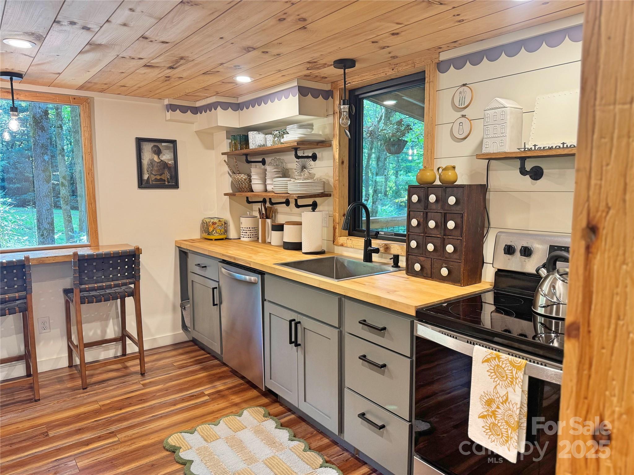 6622 Gingercake Road Newland, NC 28657 - Photo 23 of 48 a kitchen with stainless steel appliances granite countertop a sink stove and refrigerator