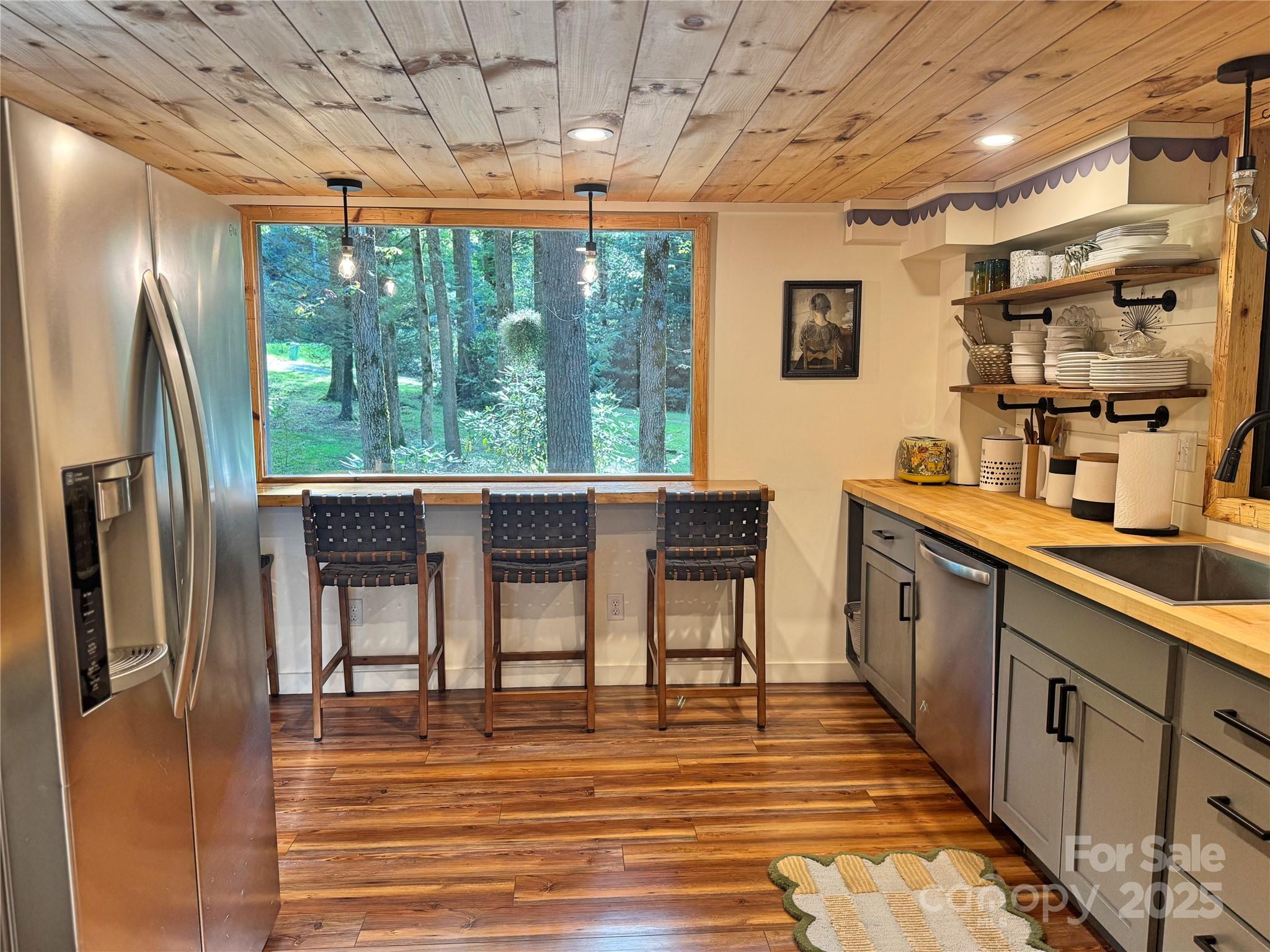 6622 Gingercake Road Newland, NC 28657 - Photo 26 of 48 a kitchen with stainless steel appliances granite countertop a sink stove and refrigerator