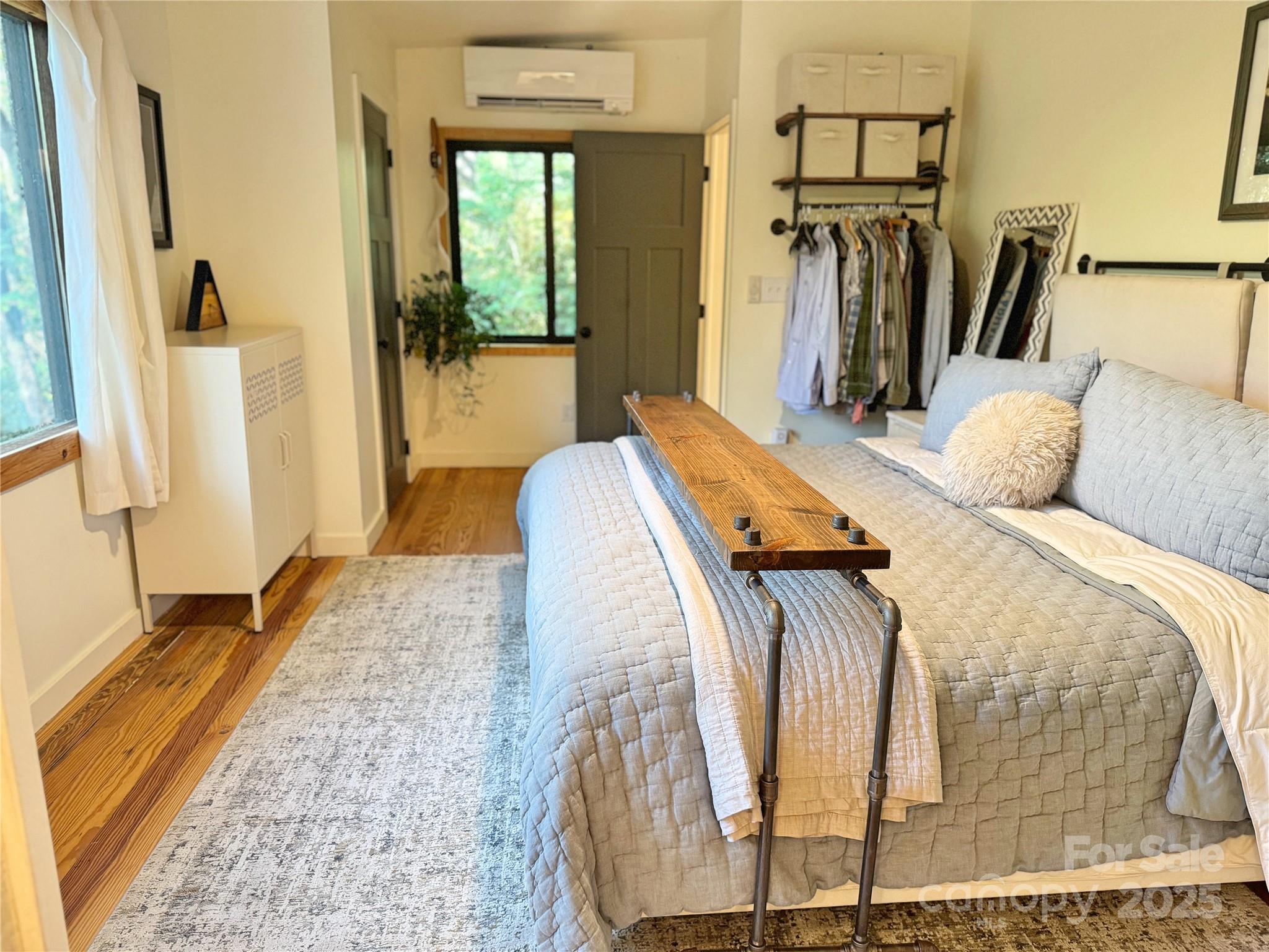 6622 Gingercake Road Newland, NC 28657 - Photo 38 of 48 a bedroom with a bed closet and a large mirror next to a window