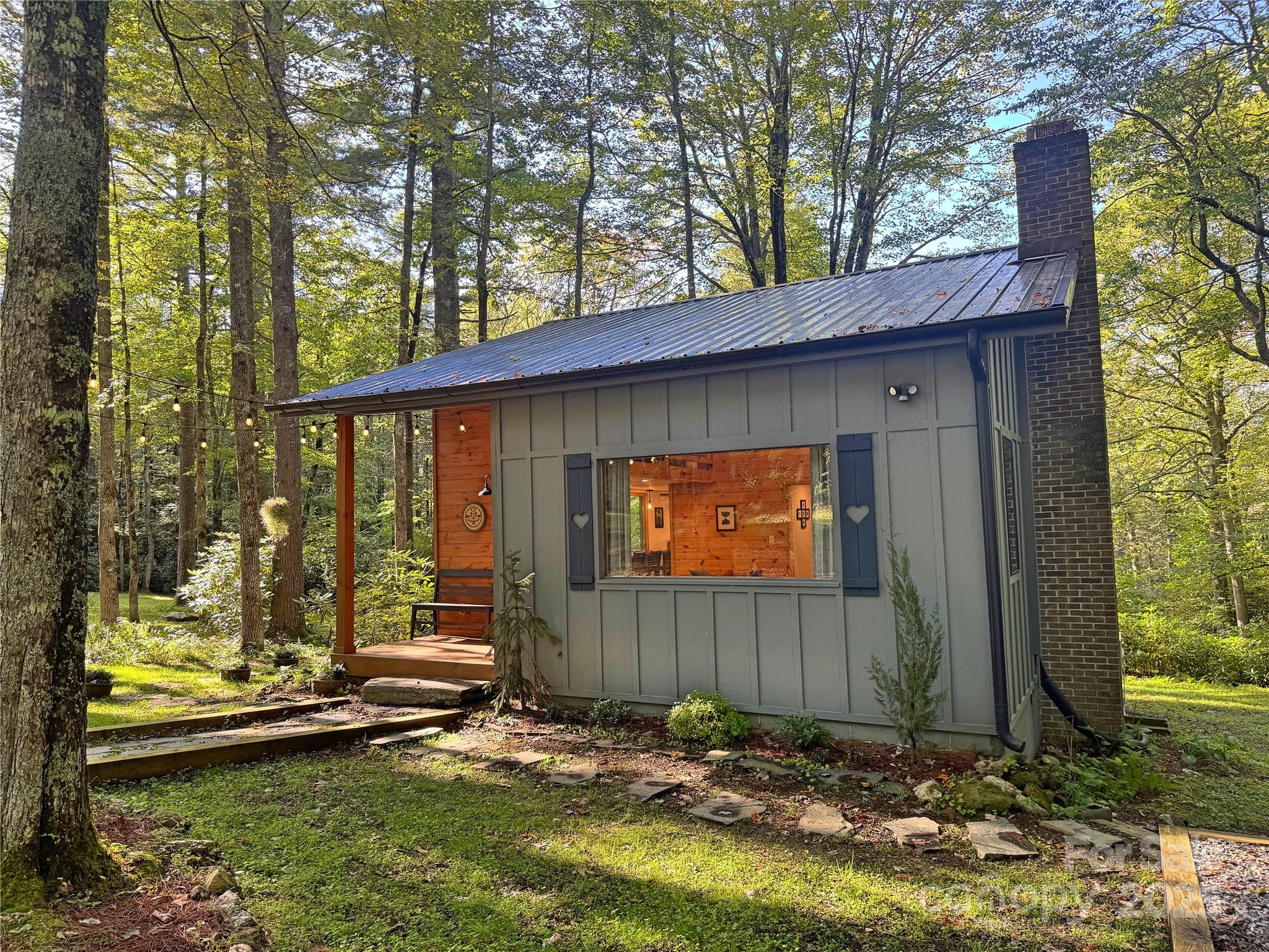 6622 Gingercake Road Newland, NC 28657 - Photo 8 of 48 a backyard of a house with a large tree and wooden fence
